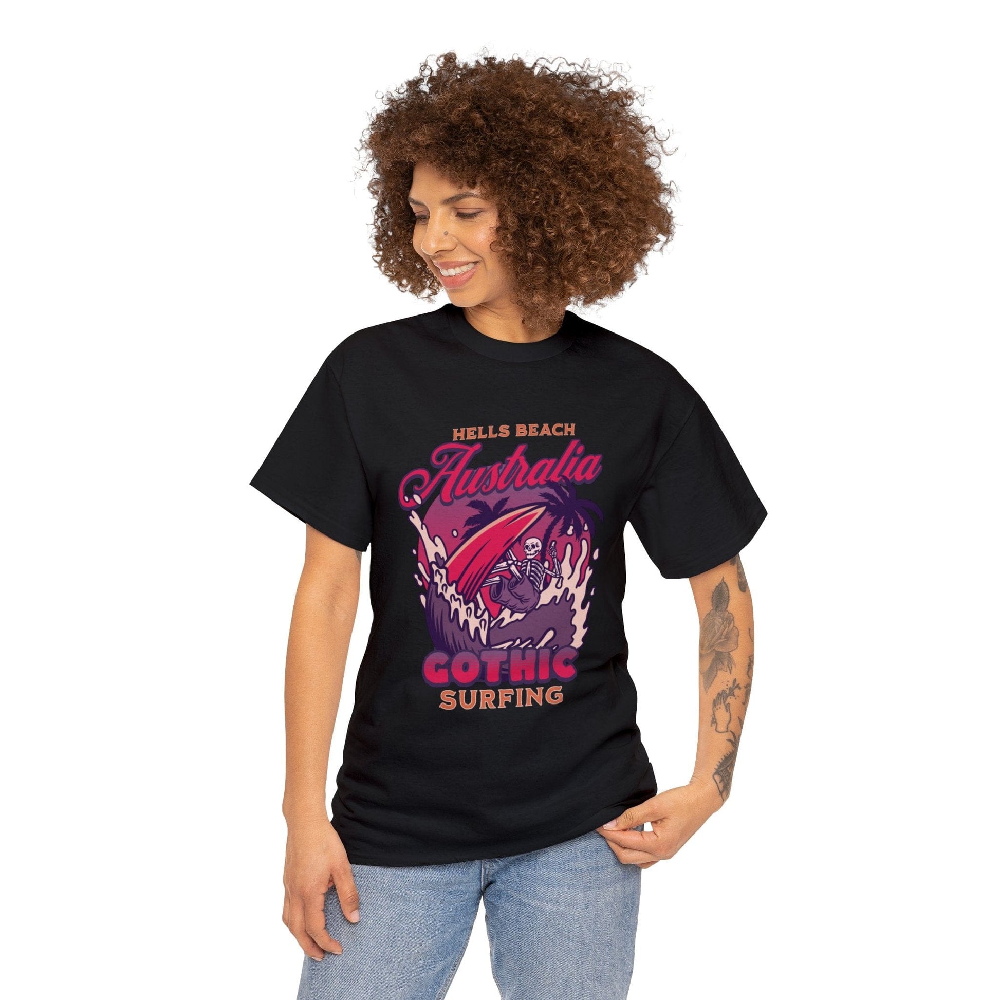 alternative mum who used to go goth clubbing wearing the women's Hells Beach Australia Gothic Surfing black Gildan 5000 t-shirt in reds, purples, halloween oranges featuring a board short wearing skeleton catching a wave under a full moon