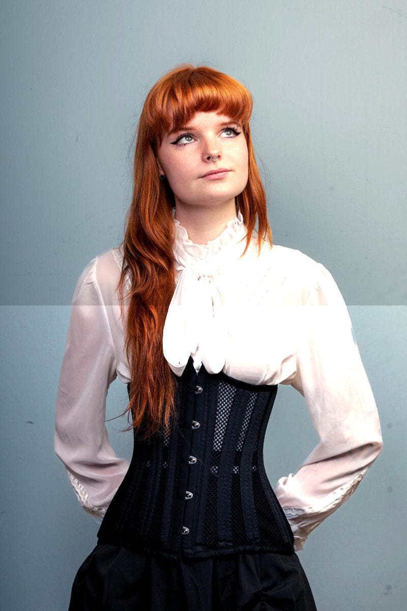 LONGLINE Waist Control Corset that is double steel boned, made from heavy duty mesh and cotton modelled by a corporate woman with red hair 1