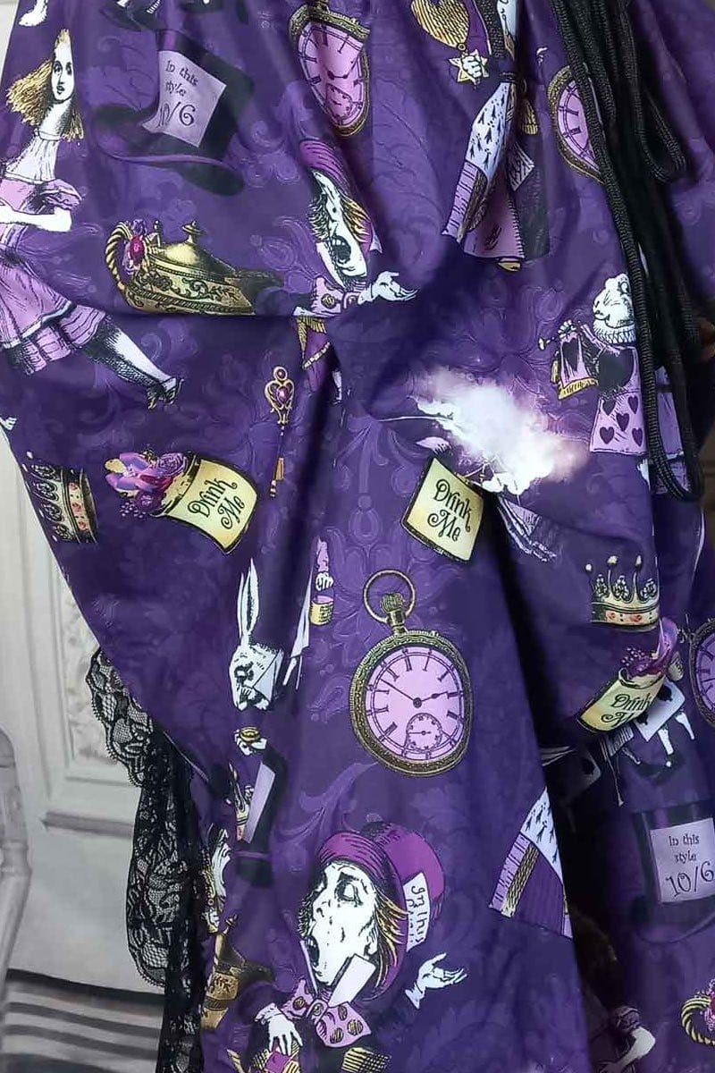 close up on the fabric of the victorian bustle high low skirt made from custom designed purple alice in wonderland fabric