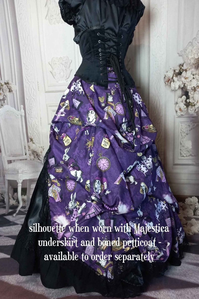 back side view of the victorian bustle high low skirt made from custom designed purple alice in wonderland fabric worn with a boned petticoat underneath