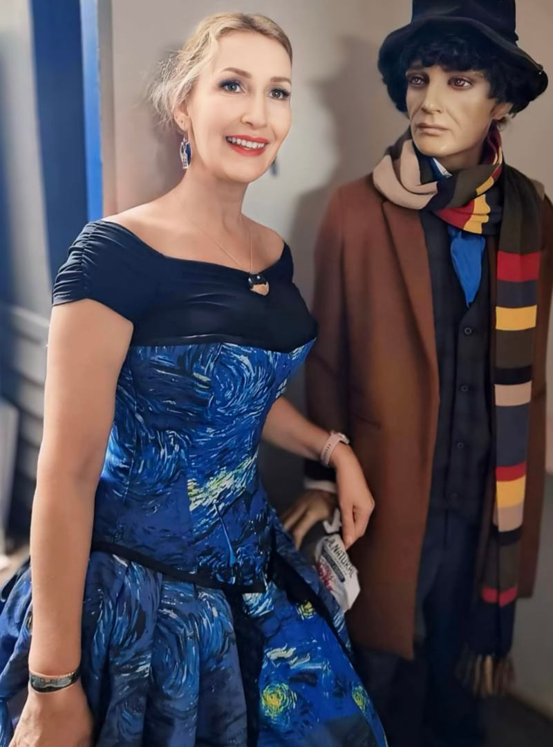 Silvia Sullivan from The Haunted Dolls Museum in Queensland wearing the Starry Night Tardis corset gown beside a realistic Dr Who mannequin