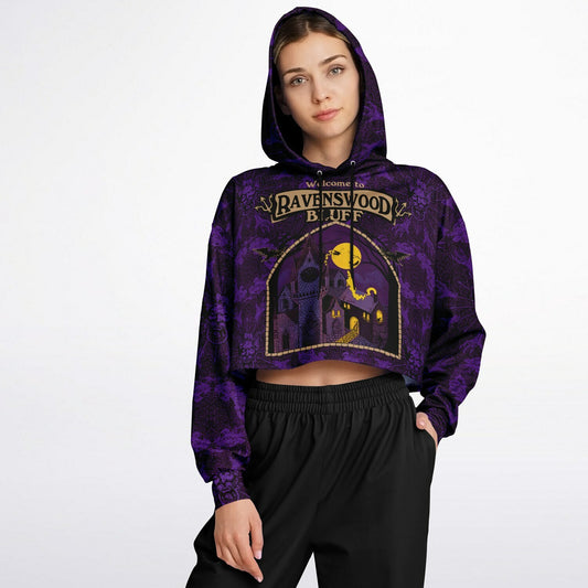 cropped short hoodie for Blood on the Clocktower fans featuring a portal view into the mythical setting of the boardgame, Ravenswood Bluff and a Welcome sign 1