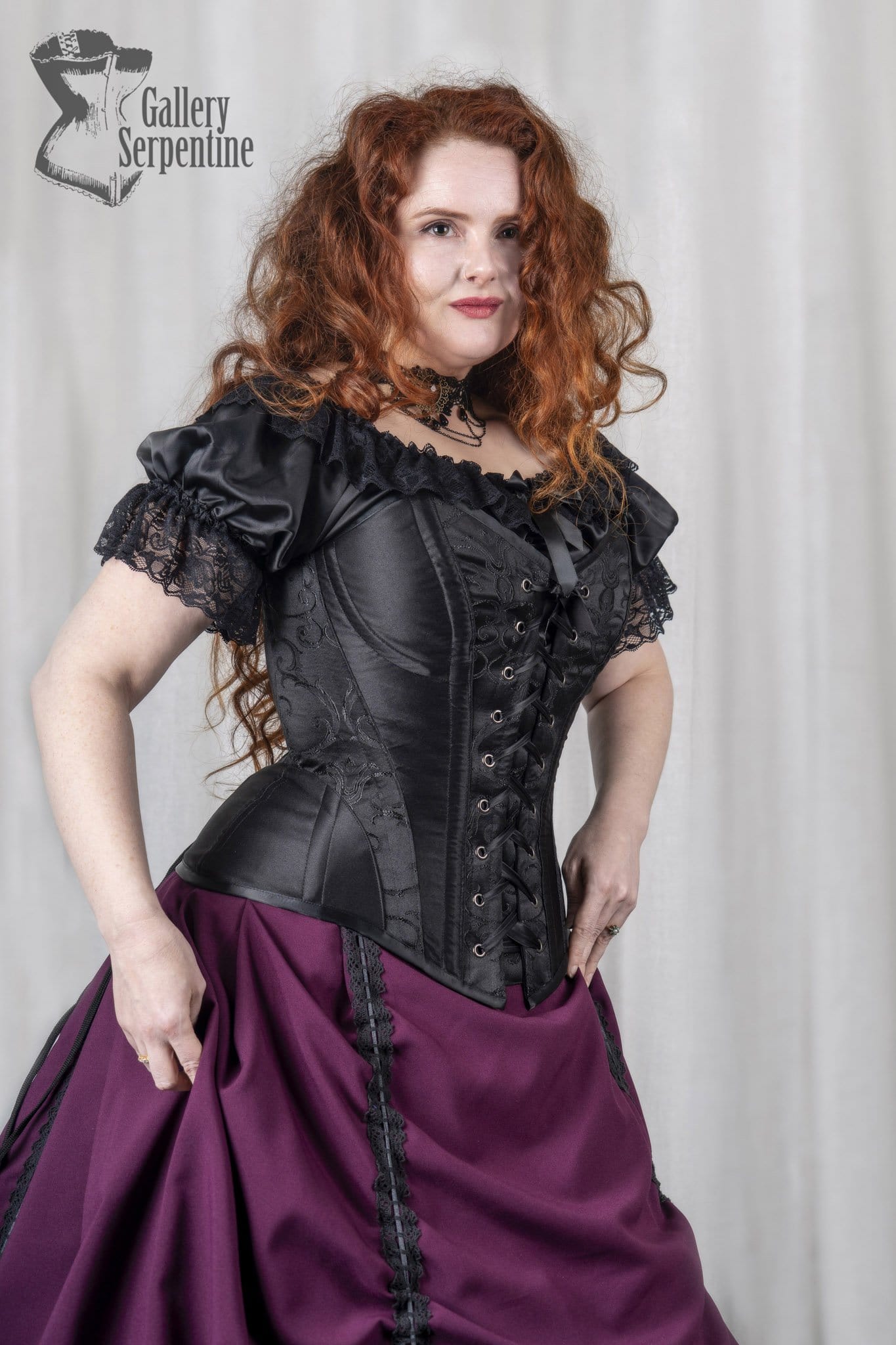 showing the hip gusset section on the new front lacing over bust corset from Gallery Serpentine in black spliced panelled fabrics