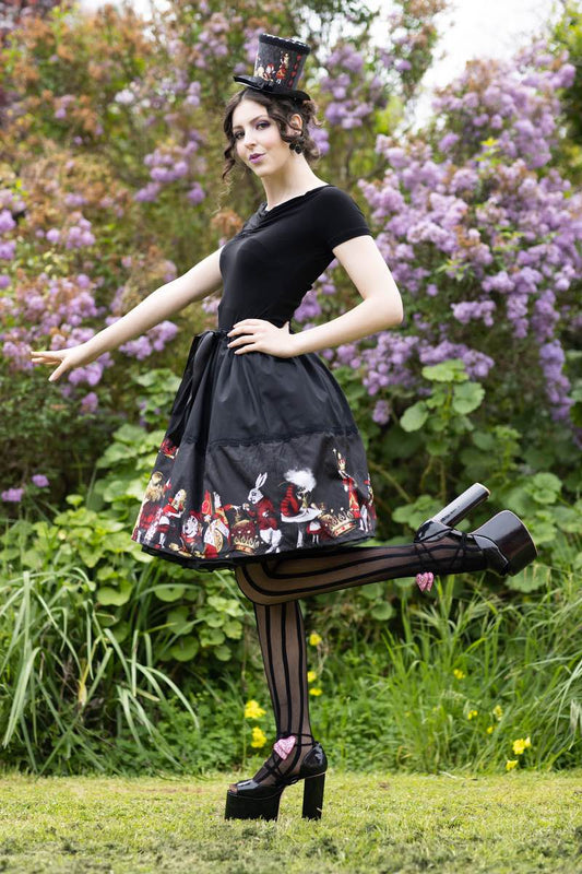 Florencia Inferno model wearing Gallery Serpentine gothic Alice in Wonderland mid length skirt featuring all the characters
