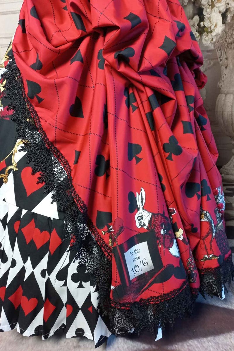 close up on the playing card feature and white rabbit with top hat from the beloved Alice in Wonderland story now on a victorian corset wedding dress or prom queen gown