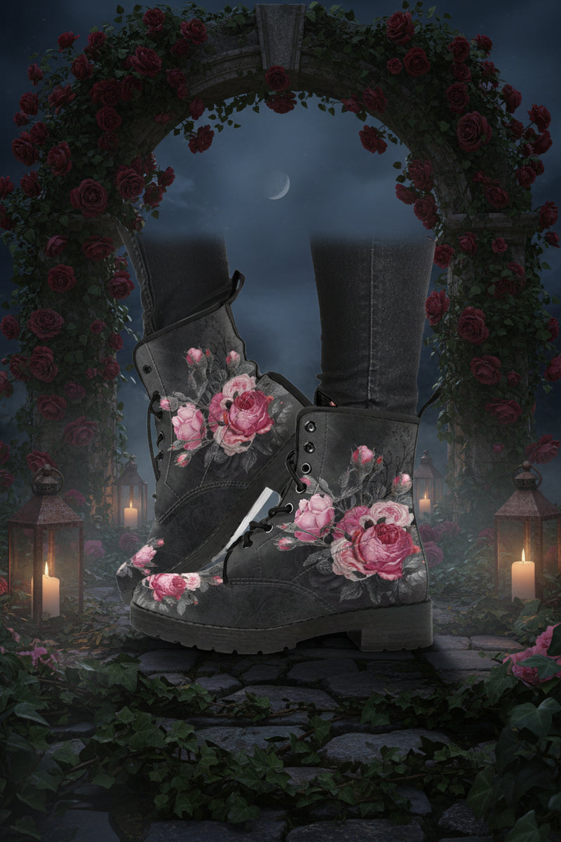 A pair of vegan women's boots with a grey base color featuring a large pink rose print, rounded toe, and lace-up front.