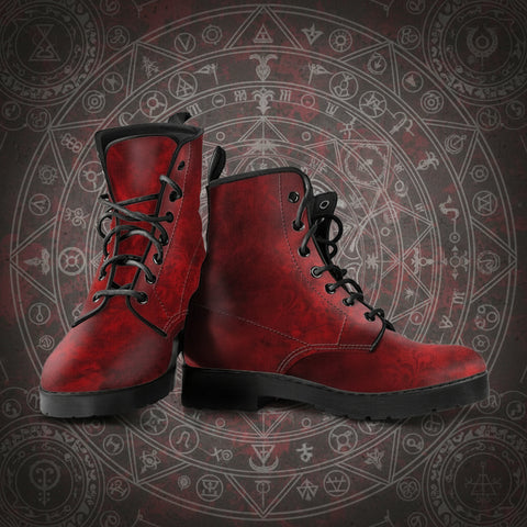 Distressed grunge look Red faux leather boots with black laces on a dark background with symbols.