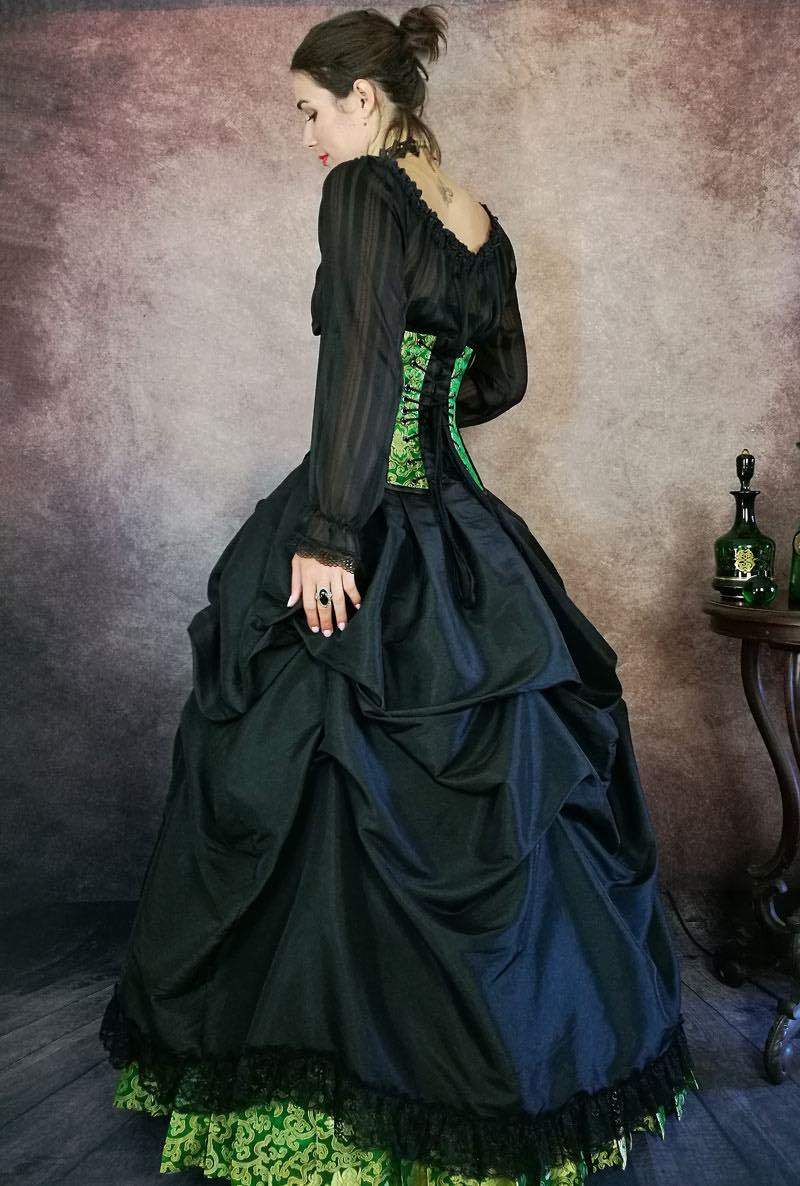 gothic victorian model wearing an emerald toned corset gown
