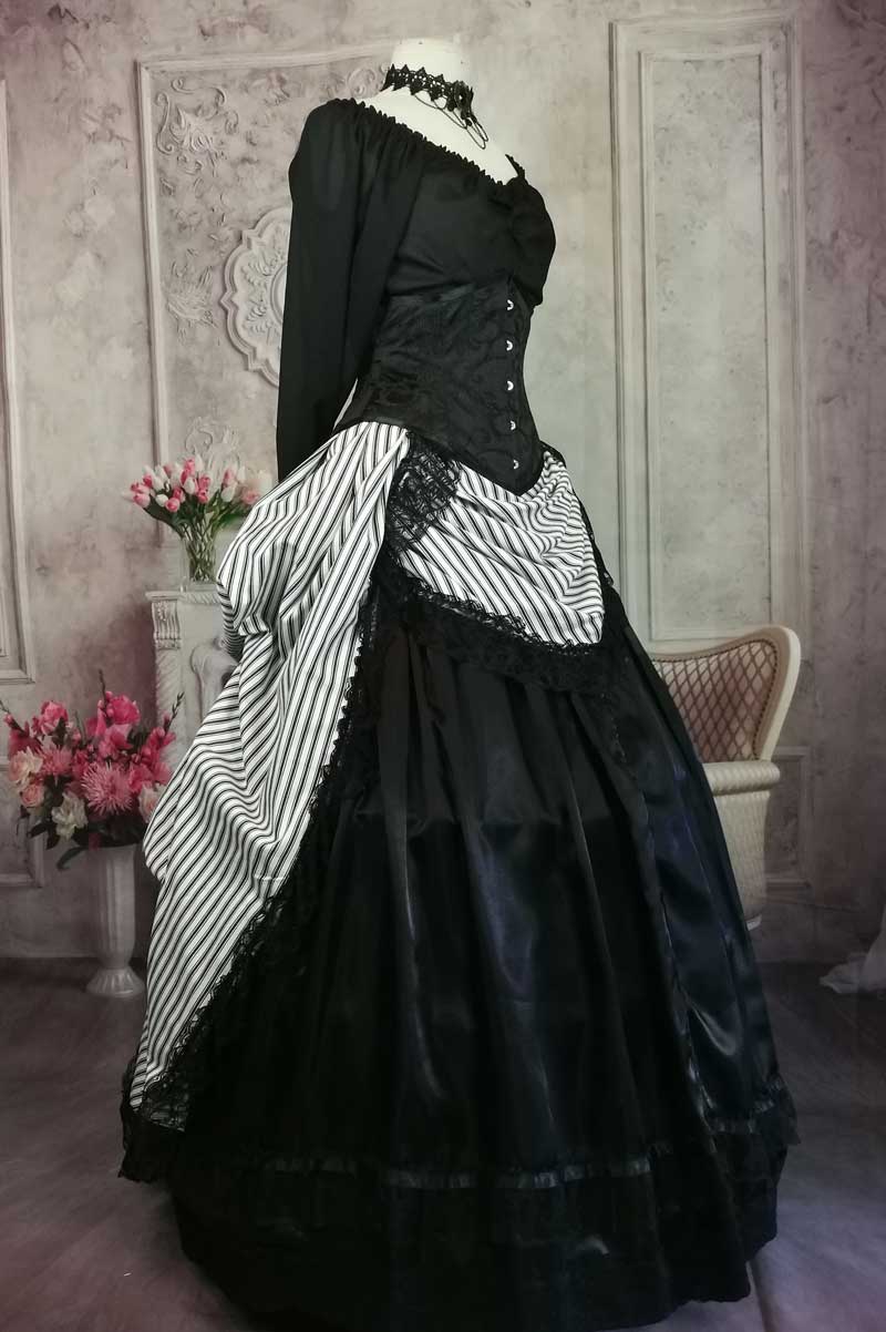 side front view of the Hampstead Heath black and white striped victorian steampunk bustle skirt worn over a boned petticoat and satin over petticoat