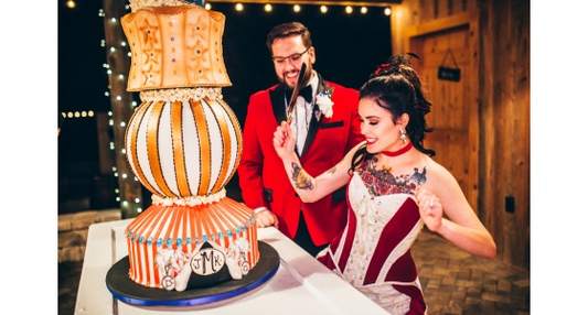 Julia and Curtis with their Greatest Showman wedding cake