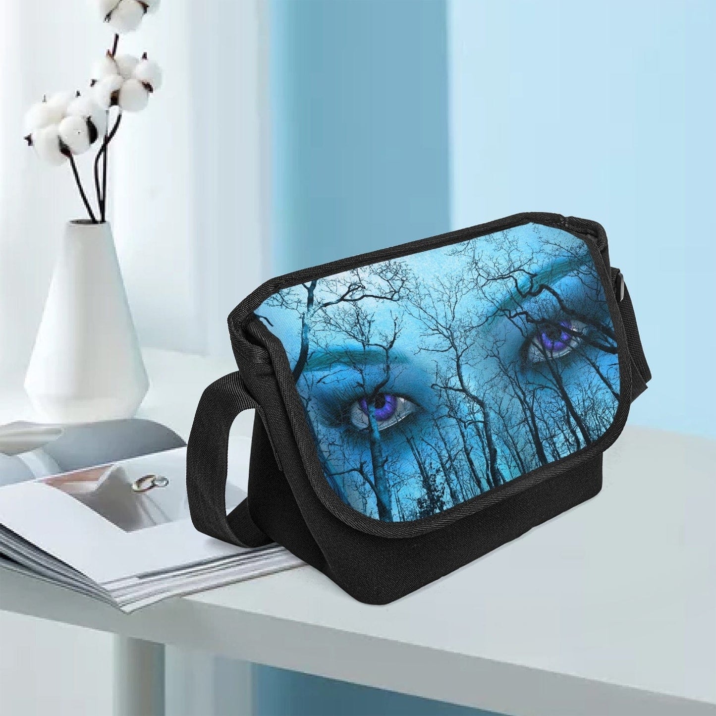 Shown sitting on a desk in a Canberra government office is this canvas messenger bag at Gallery Serpentine.  Piercing all seeing purple eyes and Blue and aqua tones give this a supernatural feel with a gothic naturecore theme.
