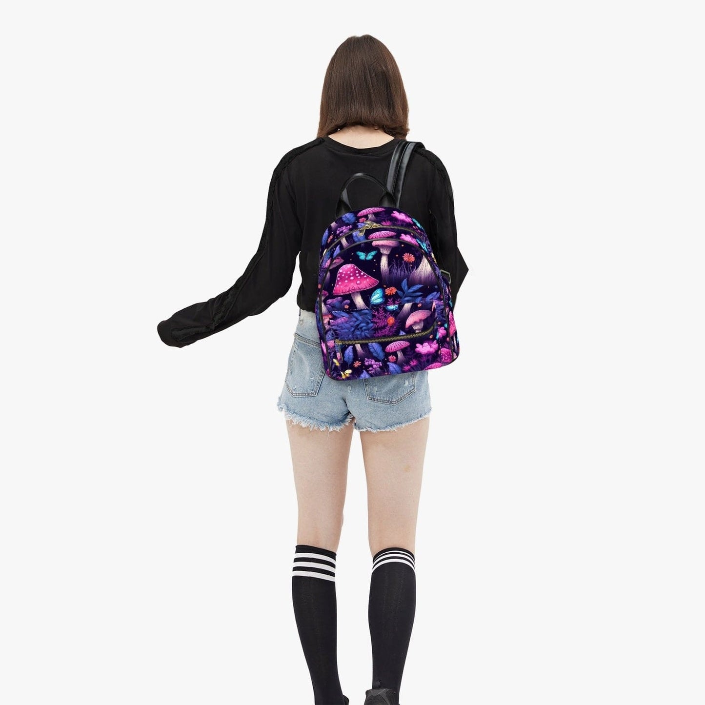 student carrying the backpack featuring a midnight garden of mushroomcore bright glowing pink and purple mushrooms printed on strong waterproof pu