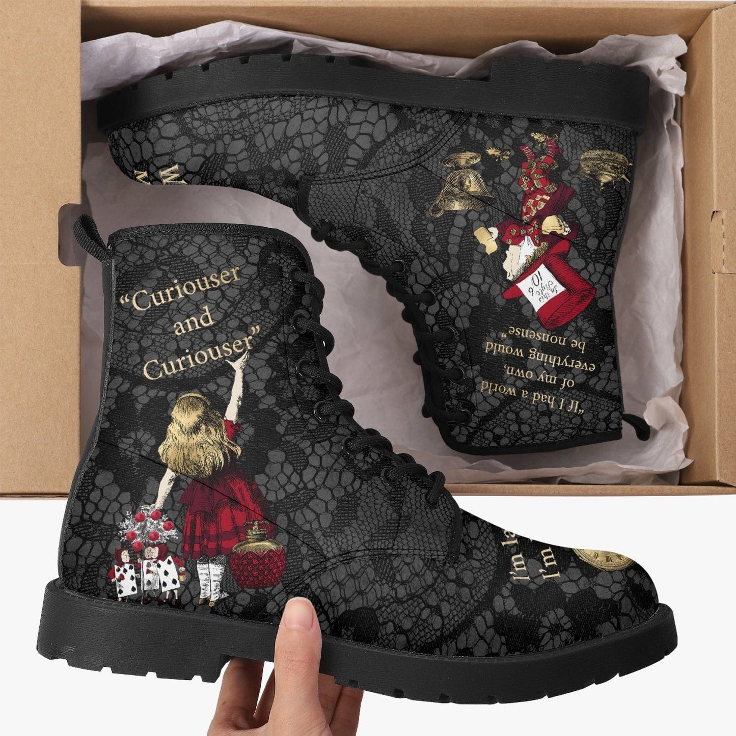 Goth girl unboxing her birthday present of the gothic Alice in Wonderland faux leather boots featuring a gothic lace background and Alice Quotes