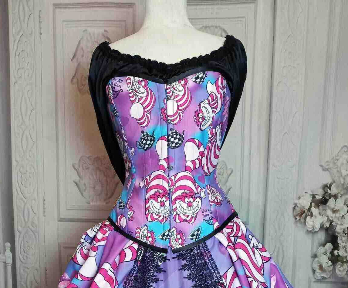 A custom-sized Victorian corset with steel boning, featuring a colorful pattern with the Cheshire Cat and hearts, made in Australia to customer measurements