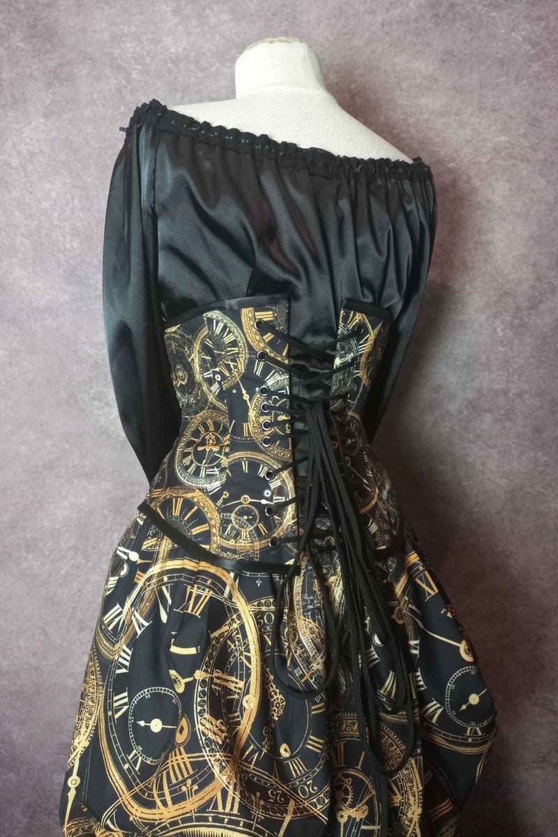 close up on the back view of the corset in the elegant steampunk victorian bustle skirt and corset set from Gallery Serpentine featuring custom made clock fabric