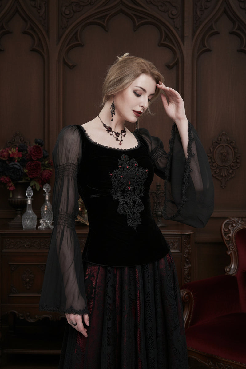 Woman wearing a black lace top with sheer bishop sleeves in a victorian parlour setting of dark wood panelling