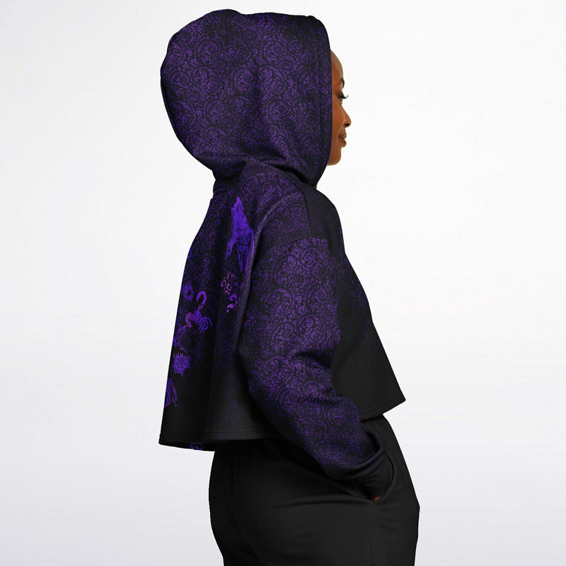 side view of player wearing the cropped short hoodie for Blood on the Clocktower fans featuring the purple and black Grimoire and character tokens