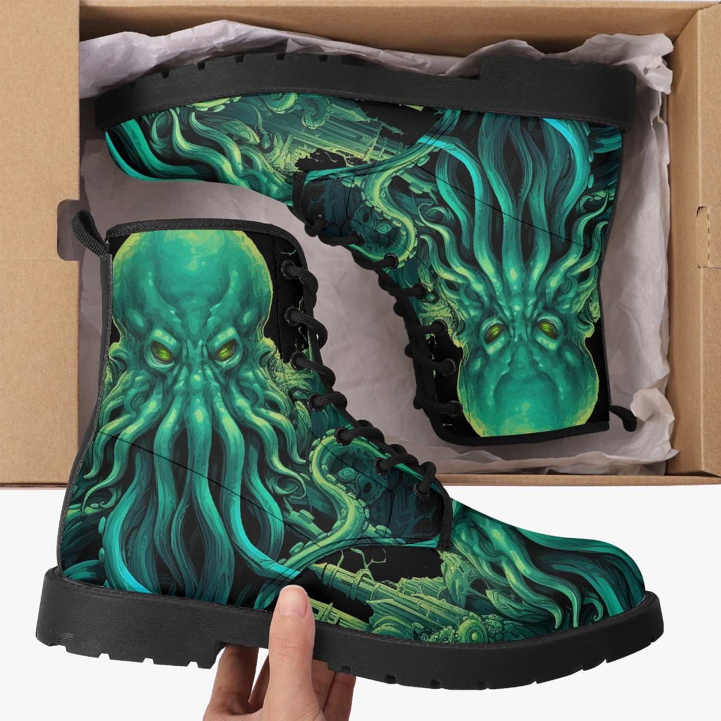 unboxing a Christmas present of a gothic pair of the mighty deep vibrant green and black Cthulhu sea monster on a vegan leather boots at Gallery Serpentine