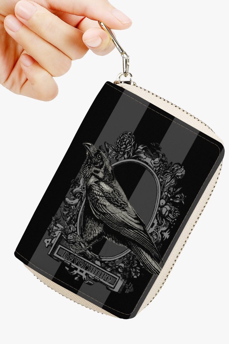 The Raven Poe Nevermore blue and black card wallet being held by a phd student at Nevermore Academy