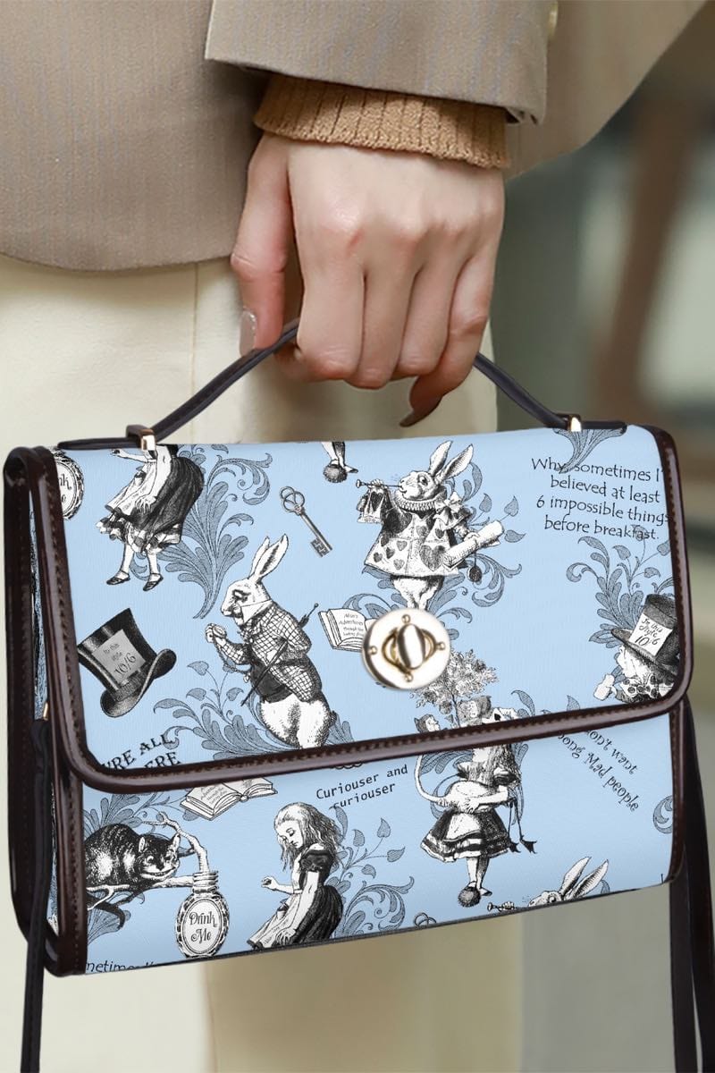 undercover agent carrying secret documents in the Alice in Wonderland whimsical blue satchel handbag printed with quotes and characters from the book