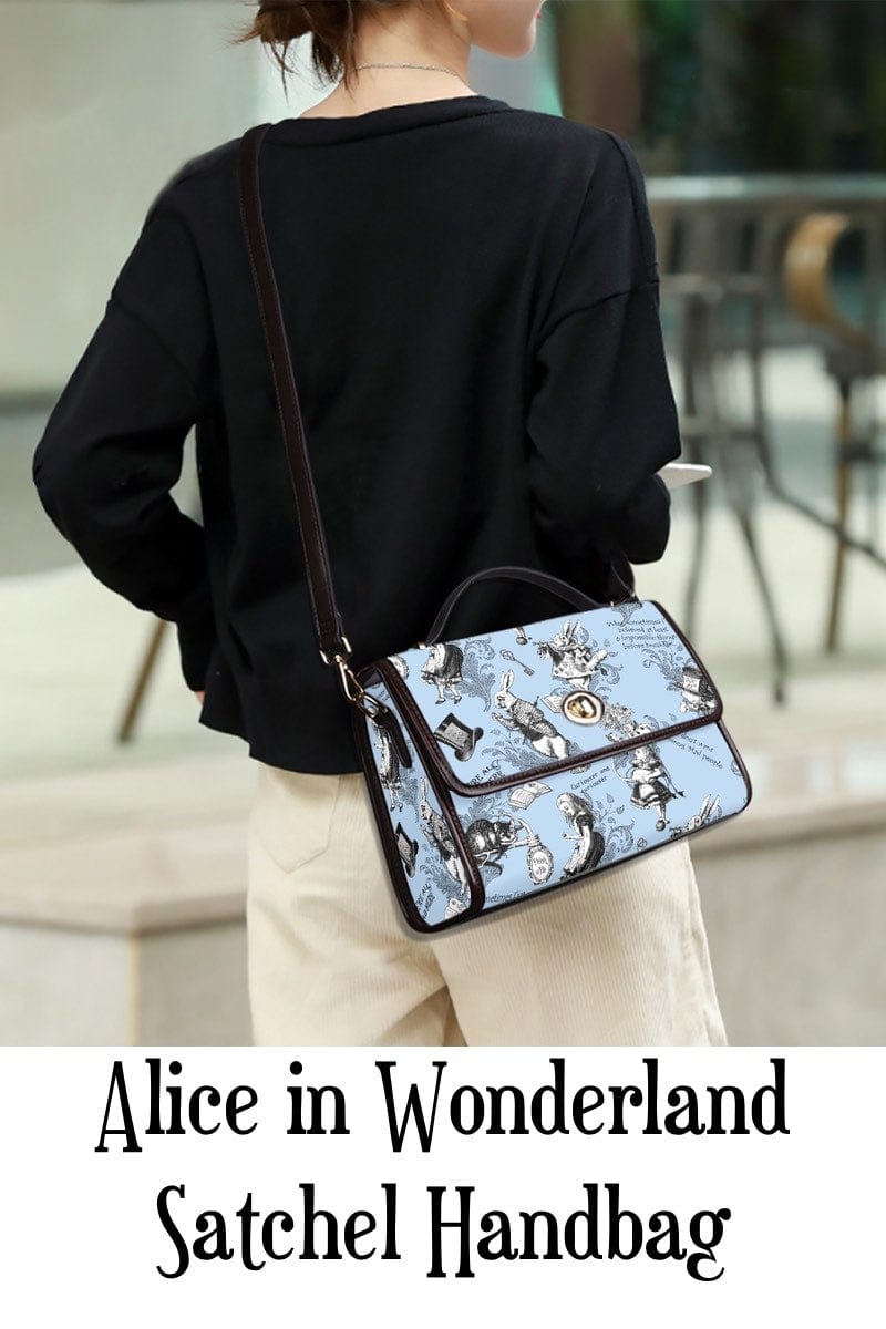 Instagram influencer wearing the Alice in Wonderland whimsical blue satchel handbag printed with quotes and characters from the book