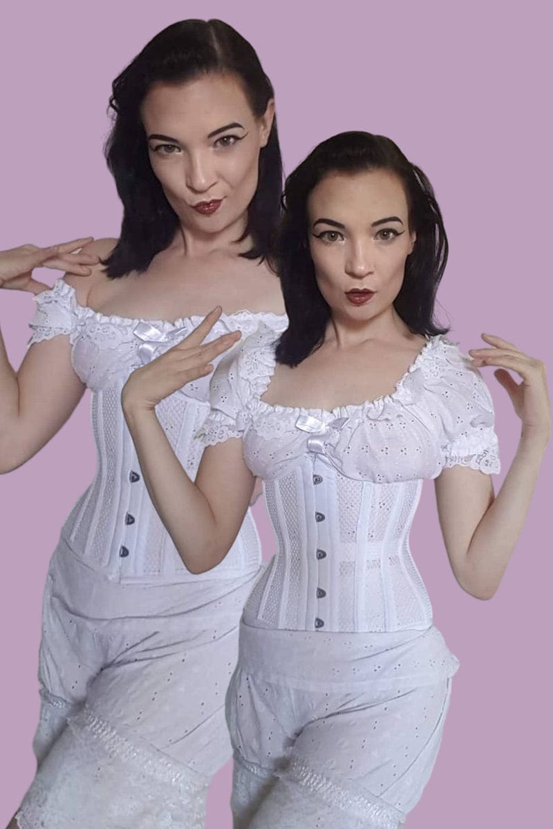 Burlesque performer and swordswoman La Petite Morticia wearing Undercover Angel white mesh waist training corset by Gallery Serpentine