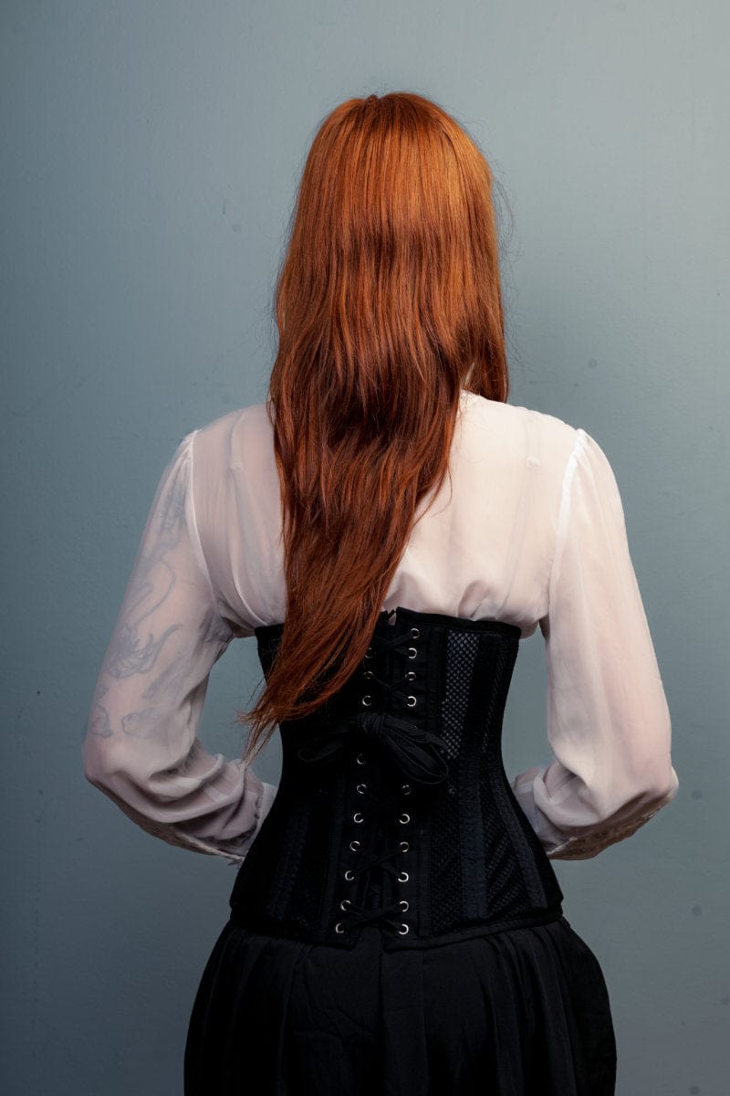 back of the LONGLINE Waist Control Corset that is double steel boned, made from heavy duty mesh and cotton modelled by a corporate woman with red hair