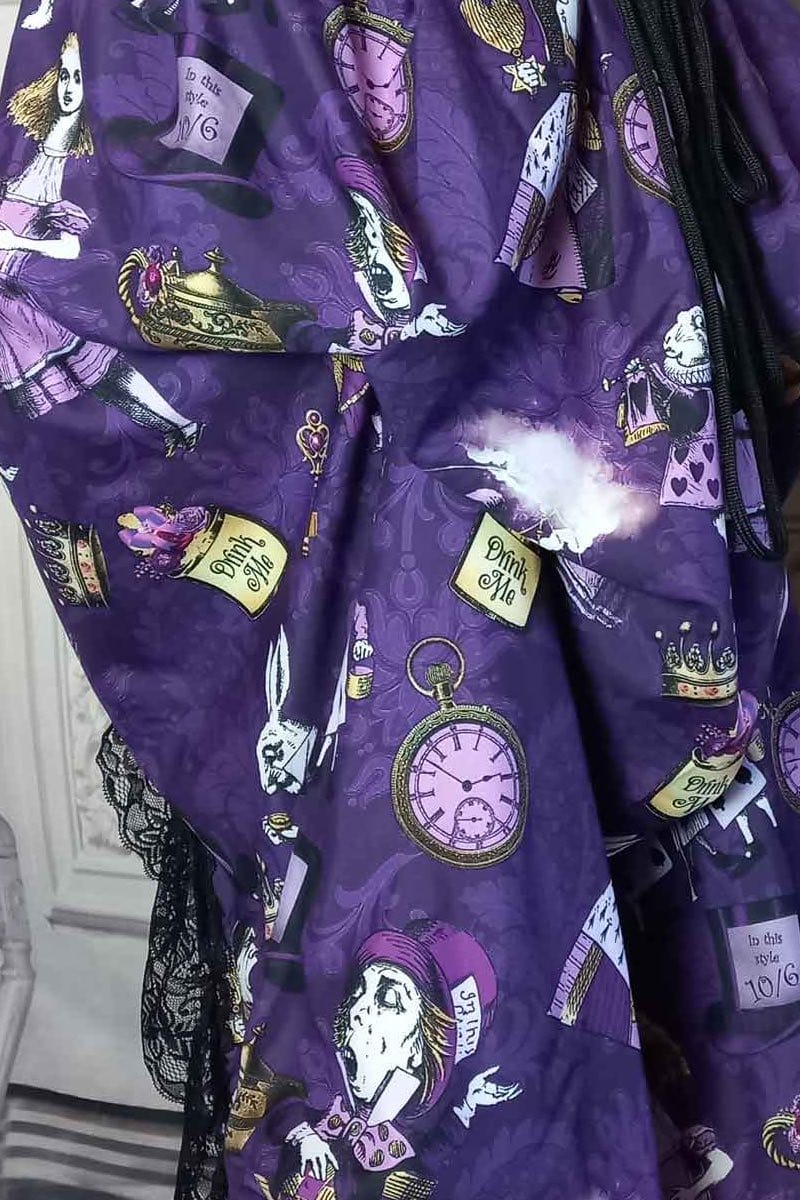 close up on the fabric of the victorian bustle  high low skirt made from custom designed purple alice in wonderland fabric