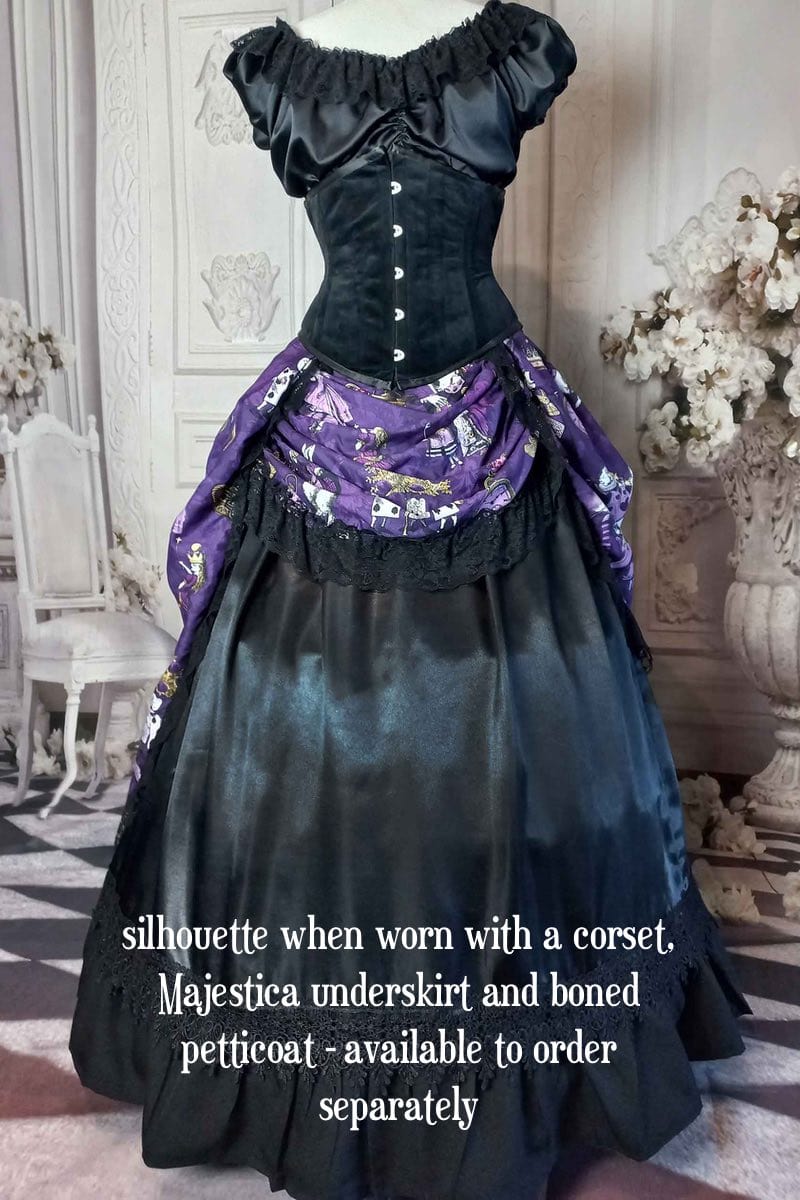 front view of the victorian bustle  high low skirt made from custom designed purple alice in wonderland fabric worn with a boned petticoat underneath