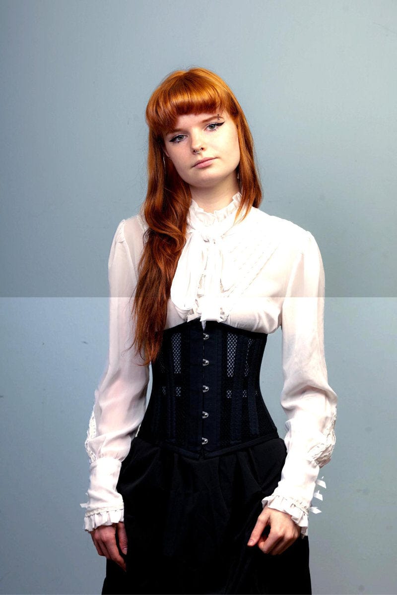 close up on the black cotton and mesh doubleboned under bust corset for waist control and posture at Gallery Serpentine worn with victorian white blouse for work