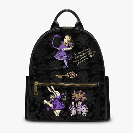 black damask patterned mini backpack featuring Alice in Wonderland characters in purples and lilacs with a famous Alice quote