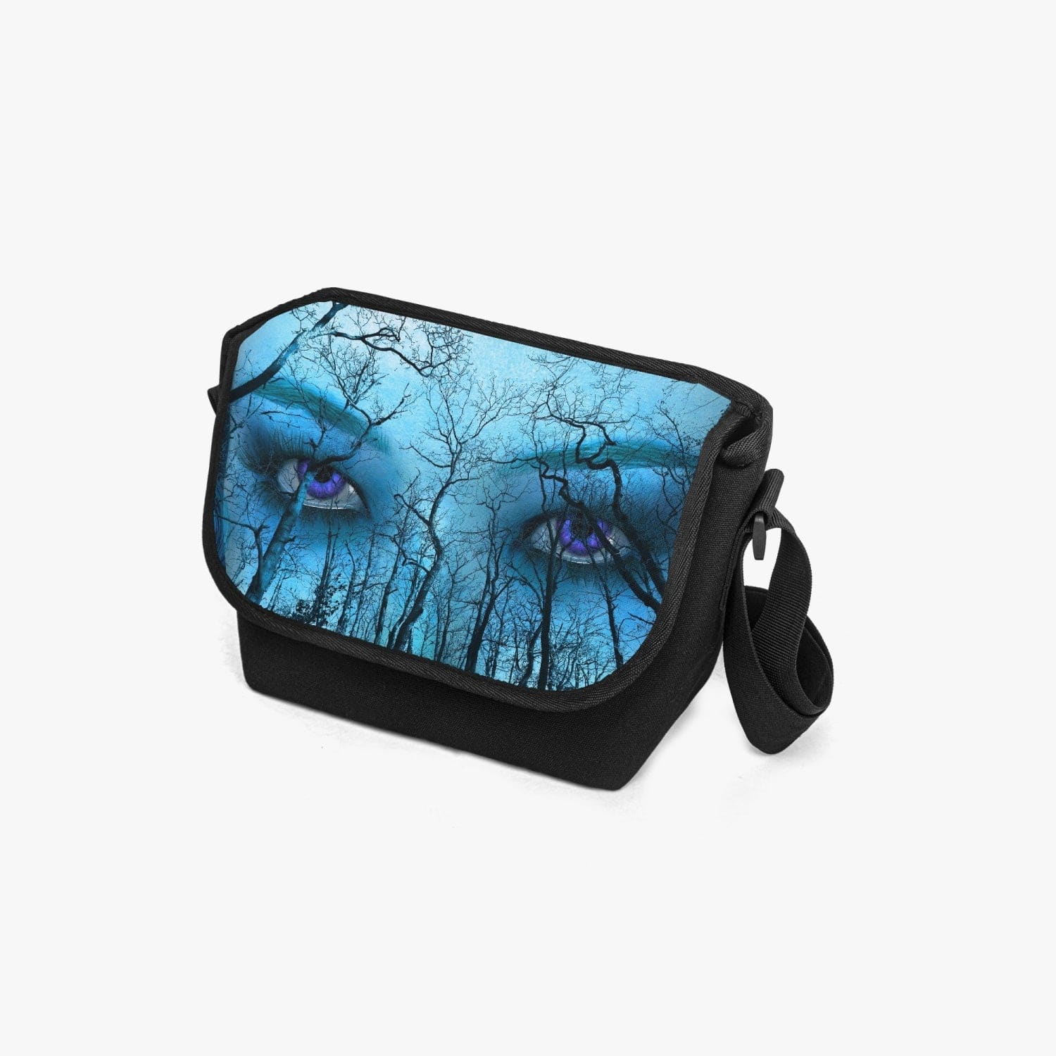 Piercing purple eyes feature on a forest themed print on this canvas messenger bag at Gallery Serpentine.  Blue and aqua tones give this a supernatural feel with a gothic naturecore theme 2