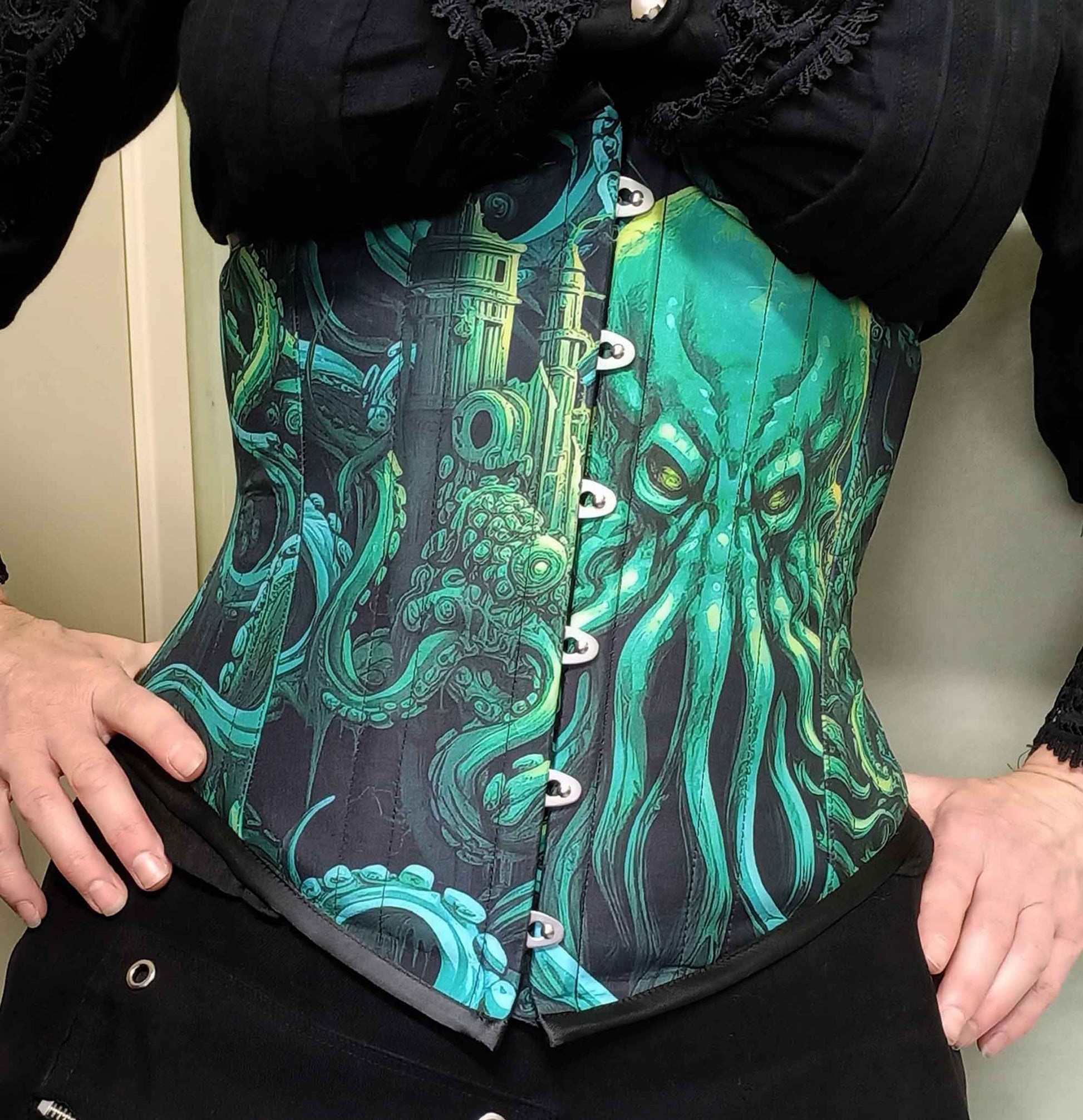 Call of Cthulhu under bust corset in vibrant and dark greens and blacks featuring the Lovecraft sea monster on an Australian made custom sized corset at Gallery Serpentine 2