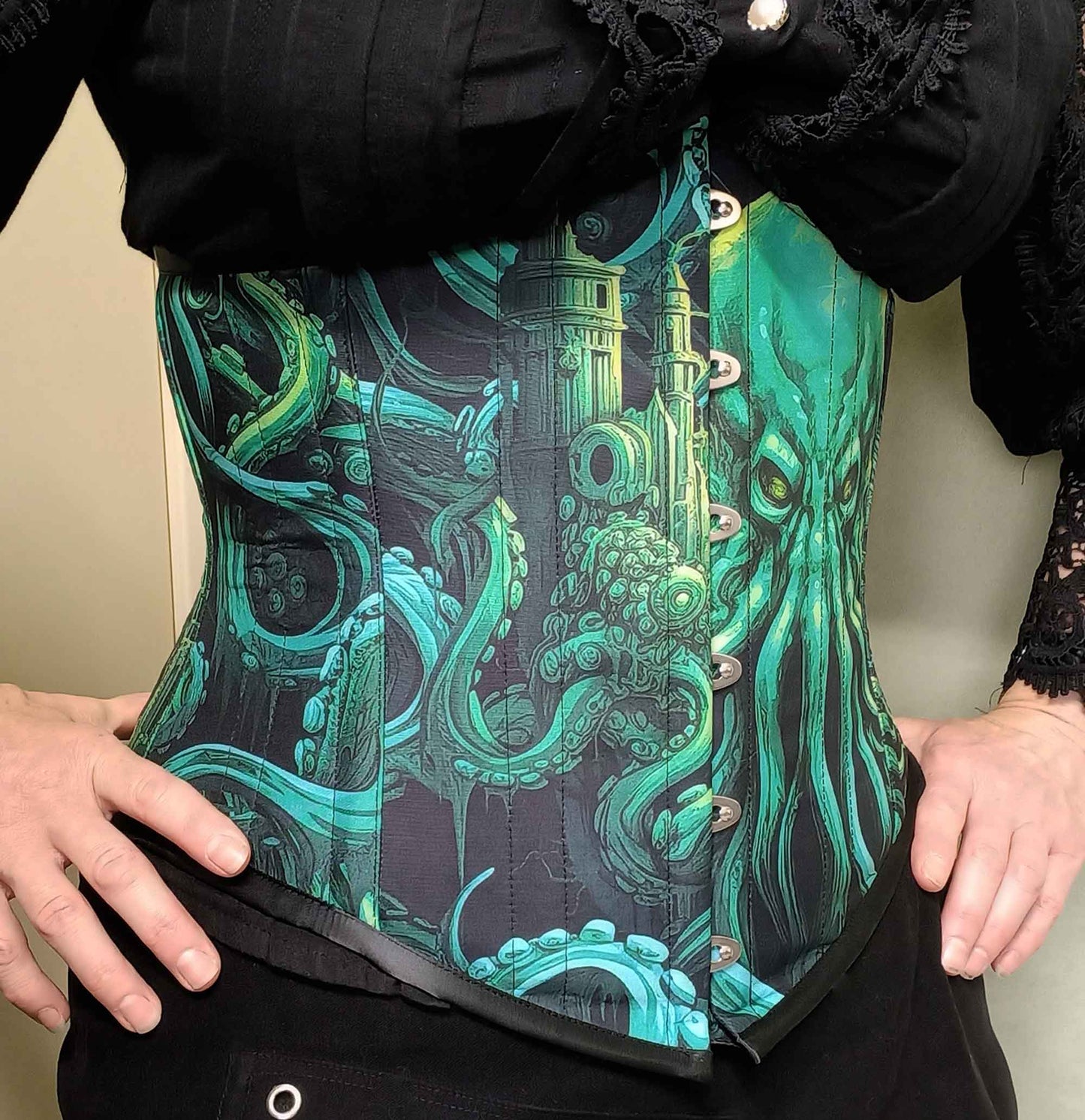 side front view of the Call of Cthulhu under bust corset in vibrant and dark greens and blacks featuring the Lovecraft sea monster on an Australian made custom sized corset at Gallery Serpentine
