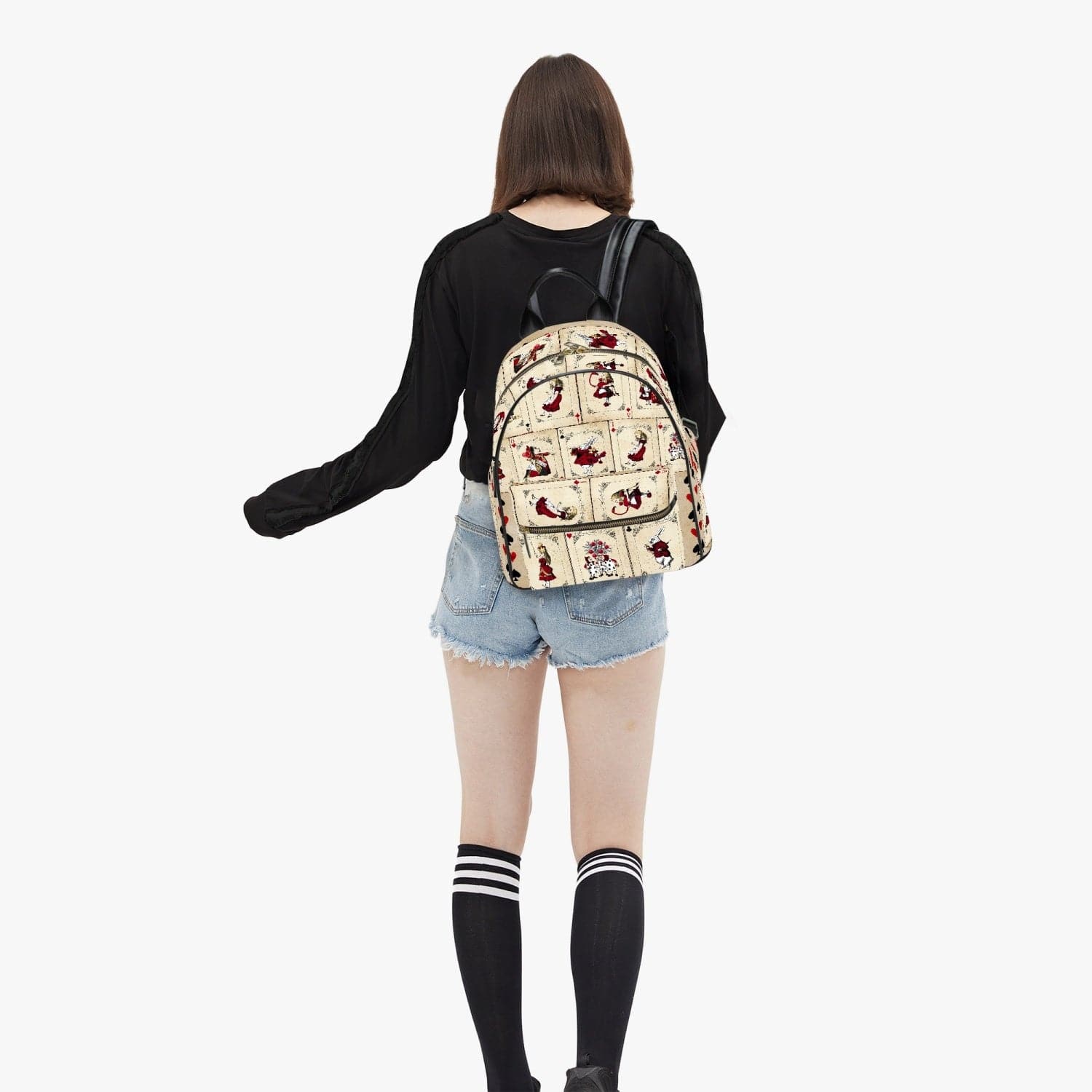 uni student carrying the Vintage retro red white and cream Alice in Wonderland playing cards print small backpack at Gallery Serpentine by the shoulder straps