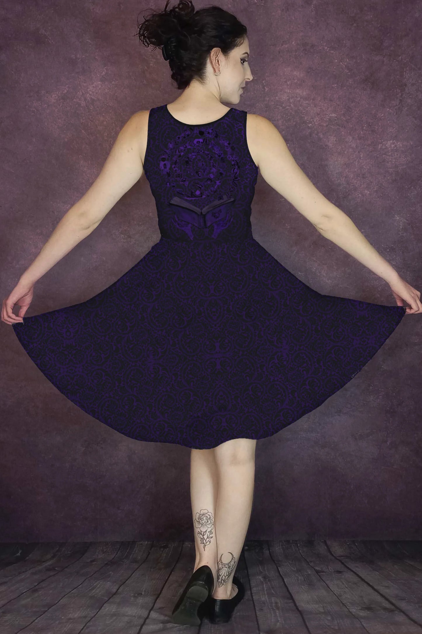 Woman wearing a dark purple dress with a baroque pattern and Grimoire from Blood on the Clocktower