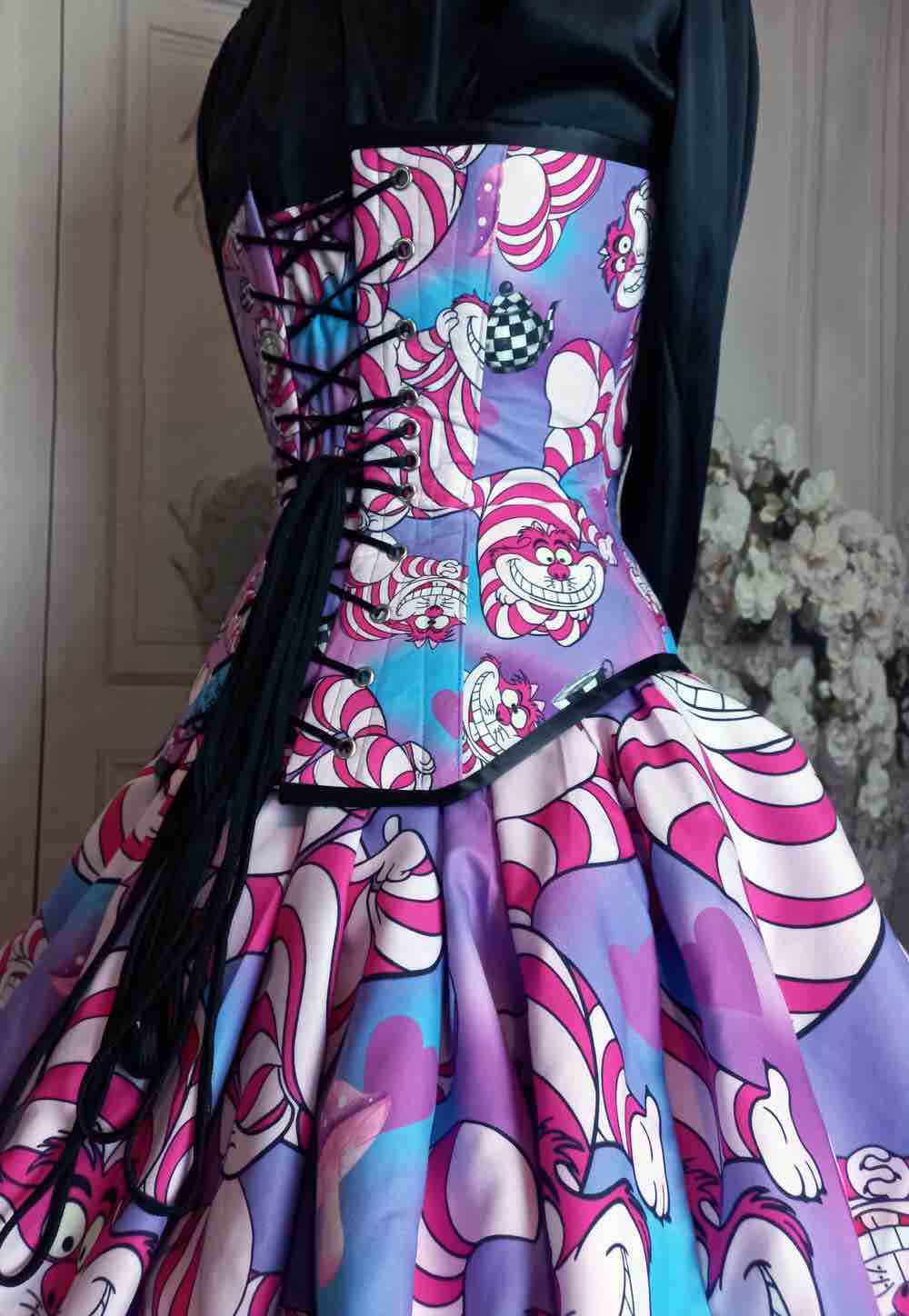 close up view of Gallery Serpentine corset featuring pink cheshire cat