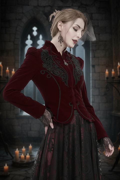 victorian female wearing dark red velvet jacket with embroidery applique feature set against a medieval castle interior with glowing candles