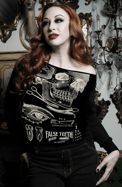 gothic alternative model wearing the raw edge off the shoulder sweatshirt featuring a vintage x-ray screen print of victorian medical malpractice chart from Se7en Deadly, made in the USA, available at Gallery Serpentine