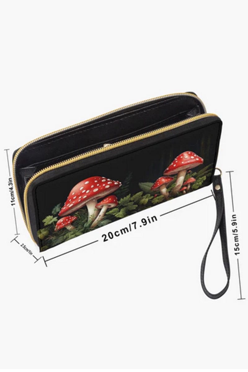 dimensions of the red and white toadstools amongst green leaves on a cottagecore vegan wallet