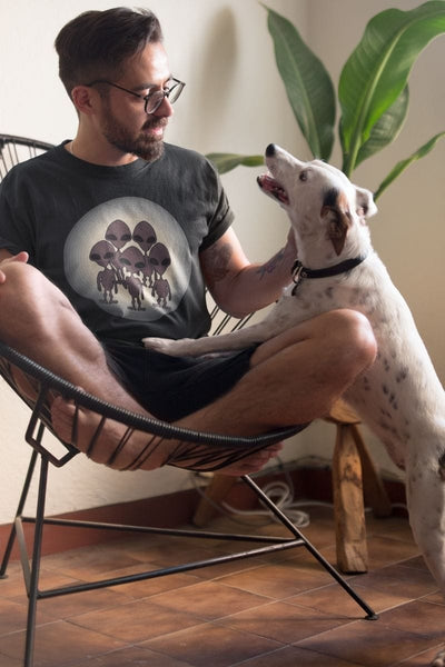Man wearing the We Came to TikTok Alien men's t-shirt with a very cute friendly white spotted dog