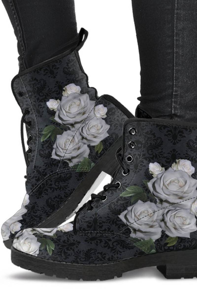 Model wearing renaissance patterned gothic boots featuring bunches of white roses