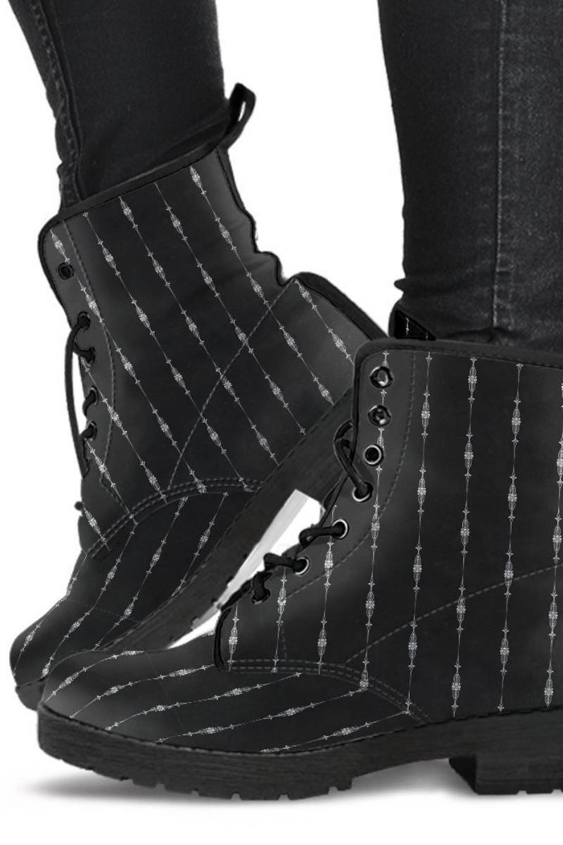 gothic pinstripe pattern on a pair of black vegan leather boots at Gallery Serpentine