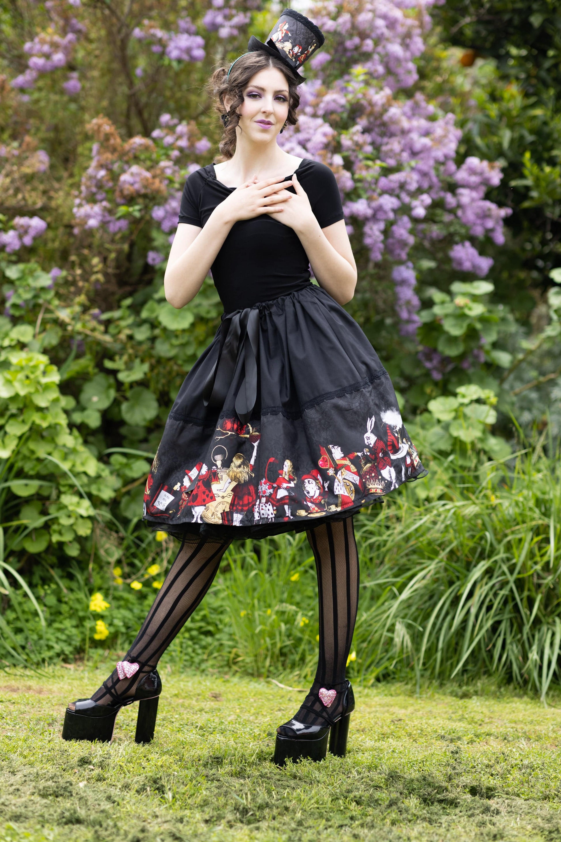 Florencia Inferno modelling the Red Gold Black Alice in Wonderland mid length skirt for Gallery Serpentine
