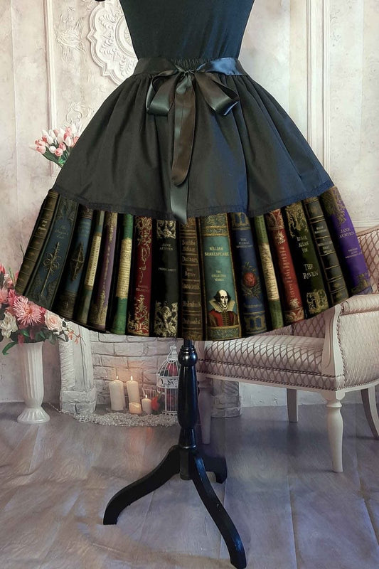 Dark Academia themed midi length full skirt made from black polycotton with a print of famous classic works of fiction, showing the spines of the books, colours are dark greens, dark reds, blacks and gold