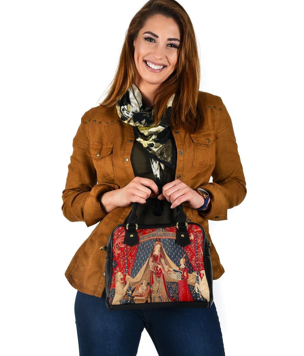 smiling woman having just received a gift of the The Lady & the Unicorn medieval tapestry artwork printed on a vegan leather women's handbag