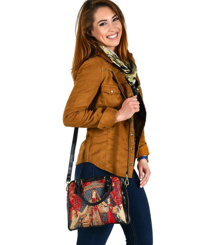woman carrying the The Lady & the Unicorn medieval tapestry artwork printed on a vegan leather women's handbag by the shoulder strap