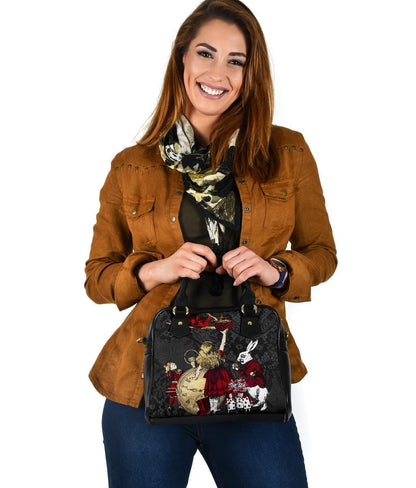 smiling woman showing her Christmas gift of the Gothic Alice in Wonderland in red gold black with a white rabbit handbag