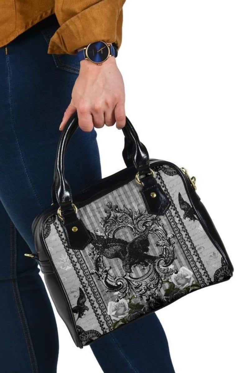 Women's gothic handbag being carried by handles
