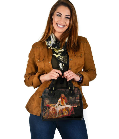 smiling woman holding her Lady of Shalott handbag out in front of her body
